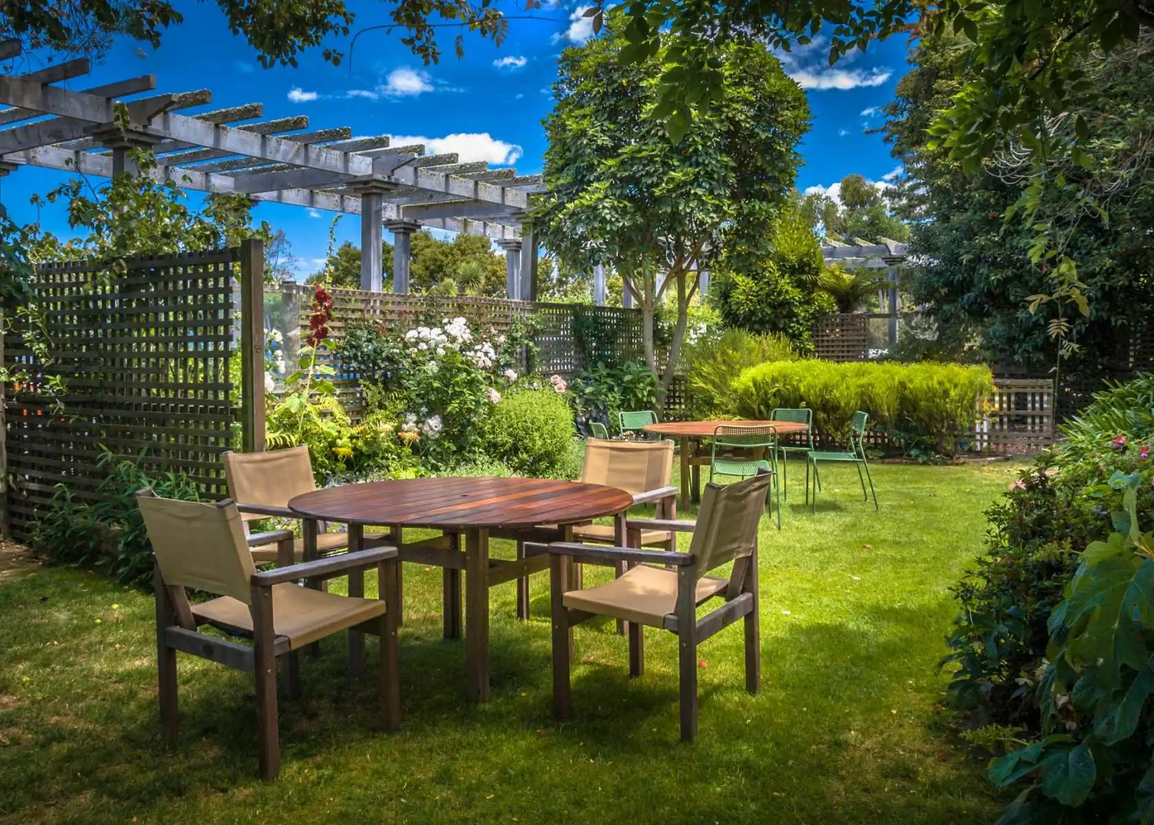 Landscaped garden with timber pergola and patio seating by Pollards Forestry & Landscaping Contractors Keighley