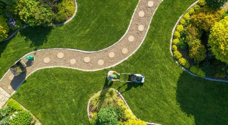 Aerial view of a landscaped lawn with winding stone path by Pollards Forestry & Landscaping Contractors